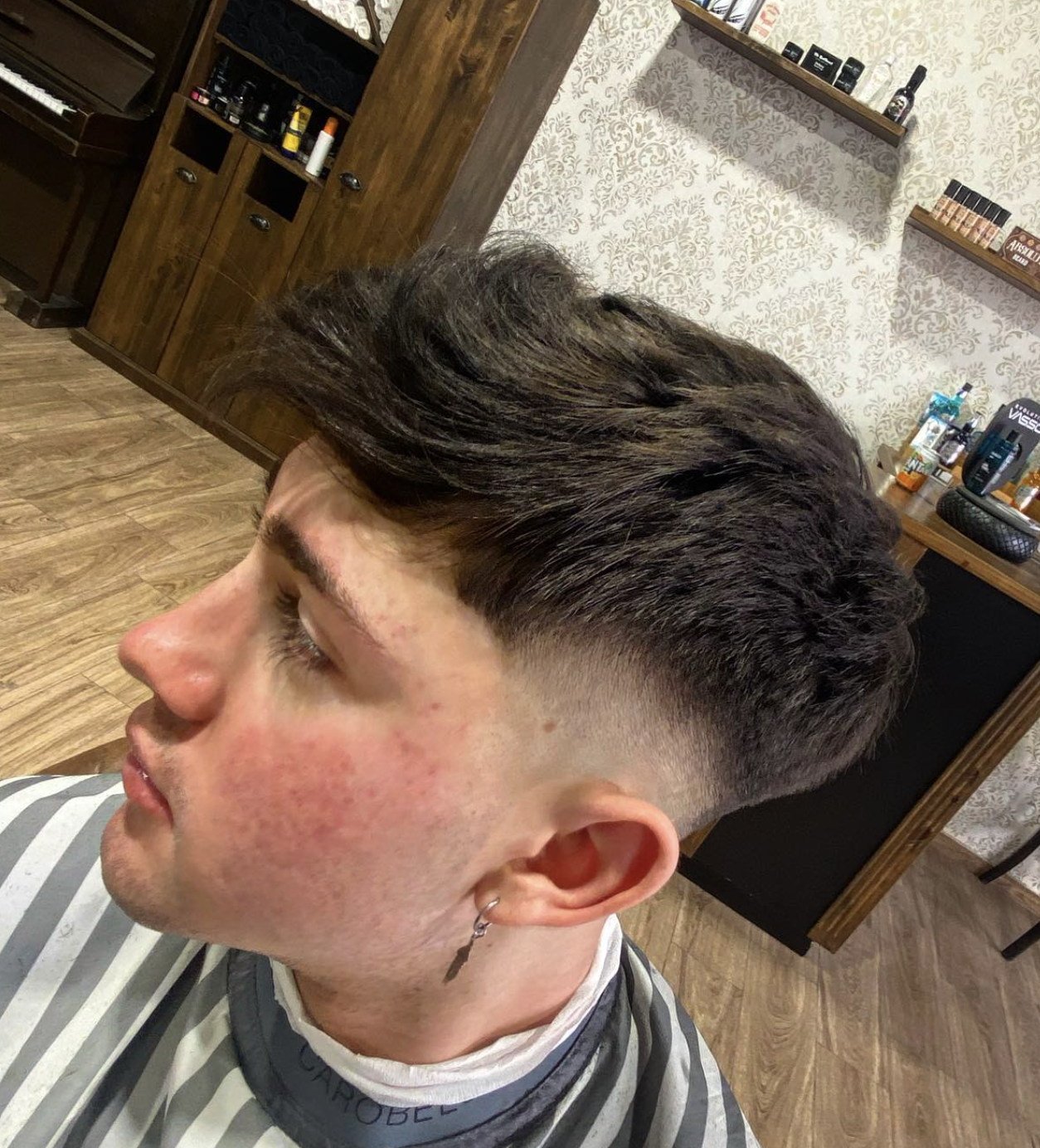 Cut with volume on top and a progressive fade done at The Barber's History