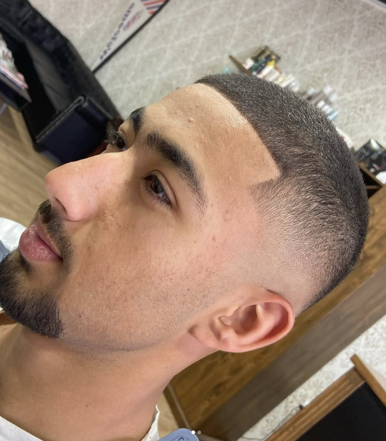 Buzz cut with a precise front hairline and premium fade done at The Barber's History